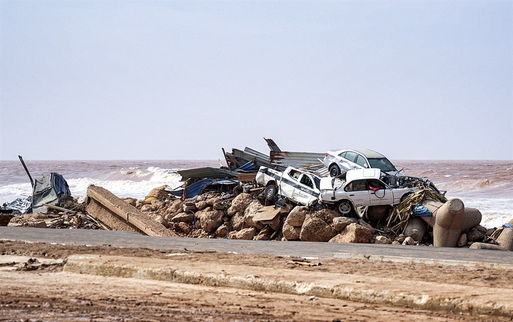 A handout picture provided by the office of Libya's Benghazi-based interim prime minister on 11 September 2023 showing vehicles piled up along the side of a coastal road in the eastern city of Derna, in the wake of the Mediterranean storm Daniel.
(Photo by The Press Office of Libyan Prime Minister / AFP) 
