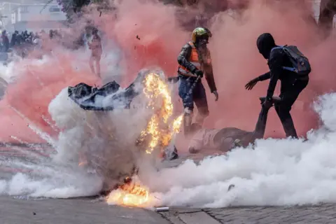 AFP A gas canister explodes at protests on Tuesday.