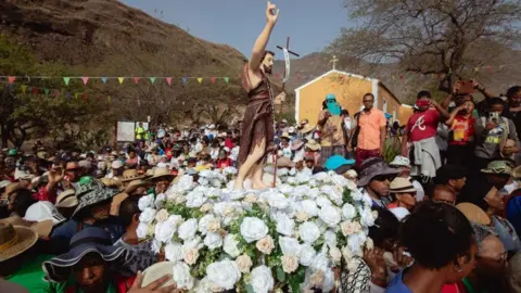 Quila Fernandes/AFP A large crowd of people take part in the pilgrimage in Cape Verde 