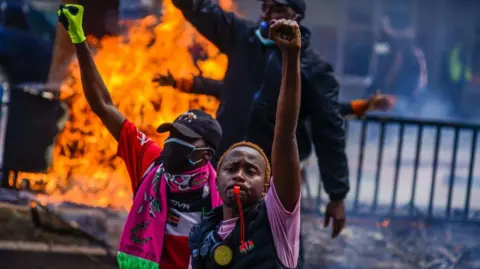 Getty Images People clash with police during a protest against the tax hikes in planned 'Finance Bill 2024' as they march to the parliament building in Nairobi, Kenya on June 25