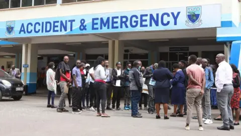 EPA Relatives of victims injured during a protest on the previous day wait outside Kenyatta National Hospital in Nairobi, Kenya, 26 June 2024.