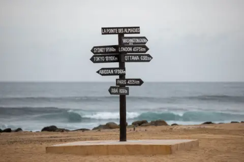 JEROME FAVRE/EPA A signpost by the sea in Dakar, Senegal.