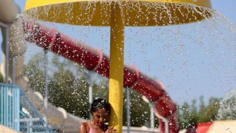 Mohamed Abd El Ghany / Reuters An image of a young girl cooling off under a water fountain at a a Red Sea resort in Hurghada, Egypt July 30, 2024.