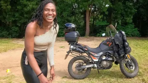 Udoh Ebaide Joy  Udoh Ebaide Joy standing in front of her motorcycle 