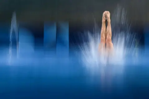 OLI SCARFF / AFP South Africa's Julia Vincent dives into the water.