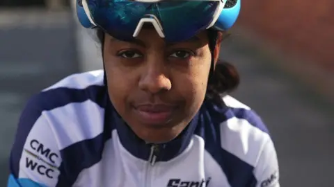 BBC Trhas Teklehaimanot wearing a helmet and sunglasses on her head