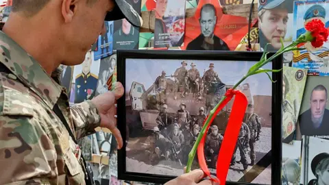 Reuters A man stands in front of a makeshift Wagner memorial in Moscow, first erected last year, during a commemoration ceremony held to pay tribute to Wagner fighters recently killed in Mali by northern Tuareg rebels - 4 August 2024