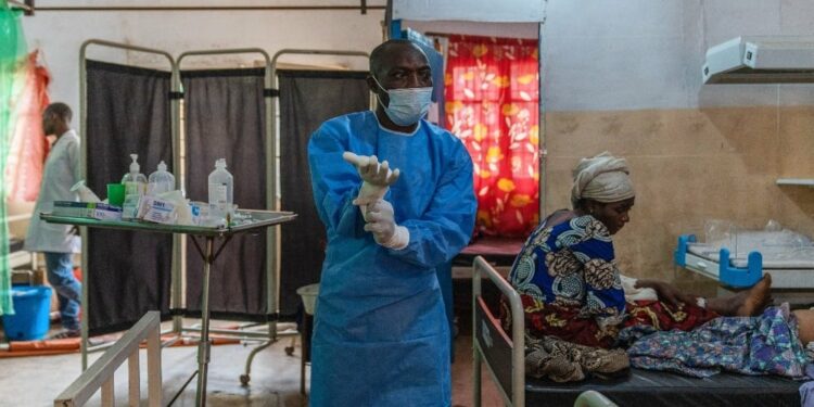 A nurse adjusts his gloves in a mpox ward at the Kavumu hospital in eastern Democratic Republic of Congo on 24 August 2024. (Glody Murhabazi/AFP)