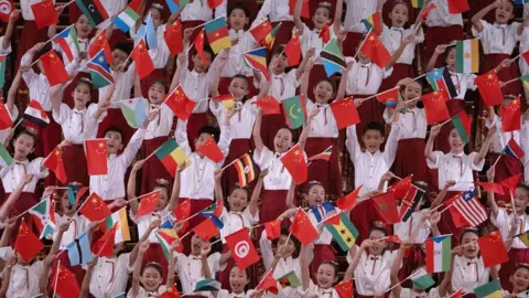 Andres Martinez Casares / Reuters Chinese children holding their countries flag alongside African countries' flags to welcome African leaders to Beijing - Wednesday 4 September 2024