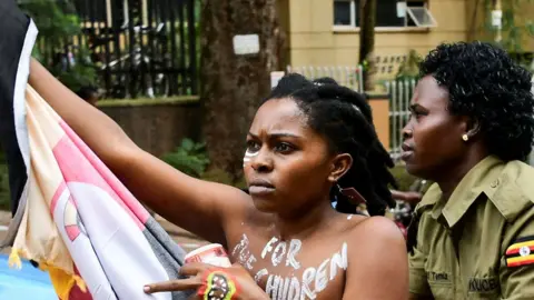 Abubaker Lubowa/ Reuters A Ugandan protester with the words 