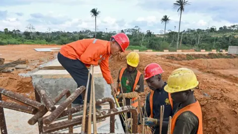 AFP Construction workers work on a highway construction site near Abidjan, Ivory Coast - 4 September 2024