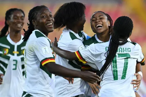 RAUL ARBOLEDA / AFP Cameroon's midfielder Achta Toko Njoya (second from right) celebrates with teammates after scoring during the 2024 FIFA U20 Women's World Cup match between Australia and Cameroon in Bogota.