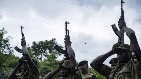 Badru Katumba/AFP An image of Ugandan soldiers doing a gun salute for Ugandan marathon runner Rebecca Cheptegei during her burial ceremony in Bukwo distric in Uganda - Saturday 14 September 2024.