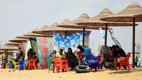 Mohamed Abd El Ghany/Reuters People relax at a private beach at the entrance of the Suez Canal, Egypt - Friday 13 September 2024.