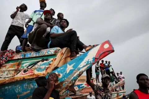 Zohra Bensemra / Reuters People watch a soccer game between two teams from the neighborhood in Toubab Dialaw on the outskirts of Dakar, Senegal, September 25, 2024