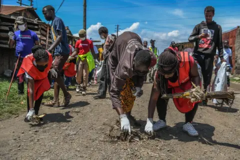 Gerald Anderson / Getty Images Kenyans collect rubbish waste during a clean-up campaign on September 20, 2024.