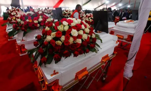  Monicah Mwangi / Reuters Kenya Red Cross workers arrange coffins before a memorial service in Kenya, September 26, 2024