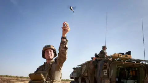 AFP A soldier of the French Army launches a mini-drone used to check the presence of jihadist groups within a radius of 2 kilometers, during the Bourgou IV operation, in northern Burkina Faso, on November 11, 2019