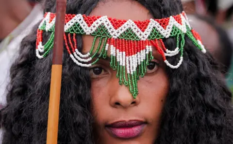 TIKSA NEGERI / REUTERS A woman dressed in a traditional Oromo costume attends the Irreecha celebration, the Oromo people's thanksgiving festival at Hora Arsadi in Bishoftu.