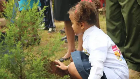 Ellyanne Wanjiku Chlystun  An archive picture of a young Ellyanne Wanjiku Chlystun planting a tree.