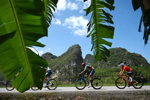 DARIO BELINGHERI/GETTY IMAGES Amanuel Ghebreigzabhier of Eritrea and Team Lidl - Trek, Xianjing Lyu of China and Team China and a general view of the peloton competing during the 5th Gree-Tour Of Guangxi 2024, Stage 5 a 165.8km stage from Yizhou to Nongla 641m.