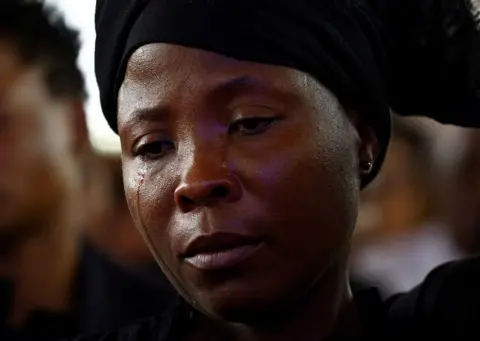 SIPHIWE SIBEKO/REUTERS Esmerada Gonsalves, widow of murdered Podemos lawyer Elvino Dias , cries during his funeral at the Paroquia Nossa Senhora do Rosario church, in Laulane township, in Maputo.