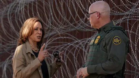 Reuters Democratic presidential nominee and U.S. Vice President Kamala Harris tours the border wall with a Border Patrol agent, near Tucson, in Douglas, Arizona, US, 27 September 2024
