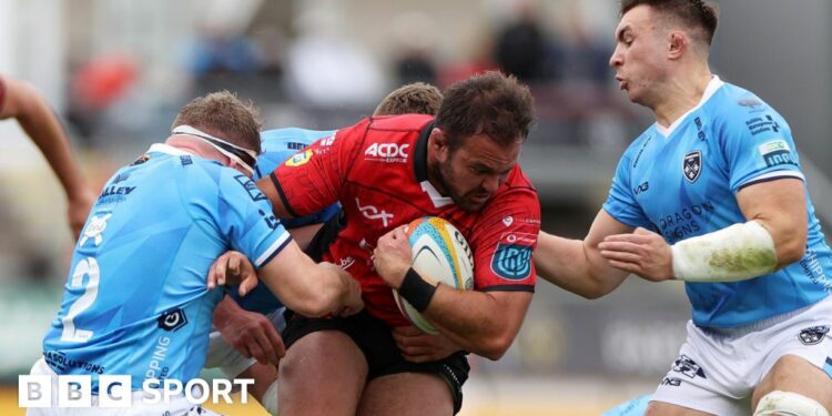 Franco Marais of Lions is tackled by Brodie Coghlan and Taine Basham of Dragons