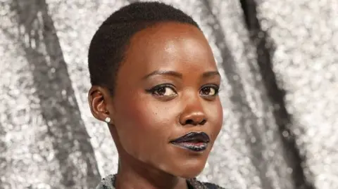 Getty Images Lupita Nyong'o poses at a film premiere