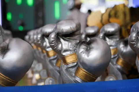 Justin Makangara / Reuters Miniature boxing gloves that are given to the winners are displayed during the closing of 2024 African Boxing Championships in Kinshasa.