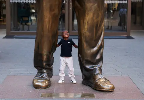 Esa Alexander / Reuters A boy plays at the feet of a statue of former South African President Nelson Mandela on Nelson Mandela Square in Sandton, Johannesburg.