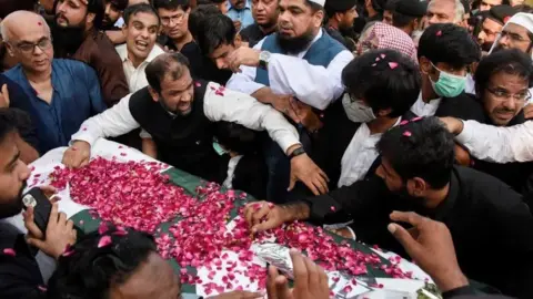 Reuters Mourners by the coffin Arshad Sharif at his funeral in Islamabad, Pakistan.