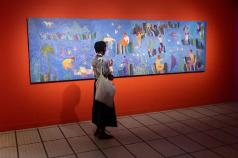 JEROME FAVRE / EPA A woman looks at a big panoramic painting. 