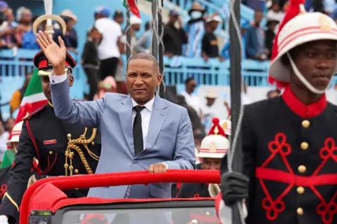 THALEFANG CHARLES / REUTERS Duma Boko waves to supporters from a car during the ceremony.