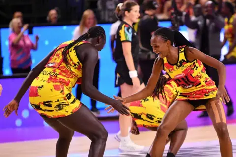 SANKA VIDANAGAMA / AFP Players give each other high-fives and dance.