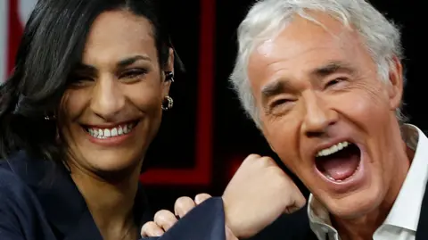 MARCO RAVAGLU / GETTY IMAGES Algerian boxer Imane Khelif, winner of the gold medal at the Paris 2024 Olympic Games, attends the Raitre Italian TV show 'Lo stato delle Cose' (lit. the state of things), conducted by Italian presenter and journalist Massimo Giletti (R).