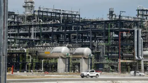 Getty Images Dangote Petroleum Refinery, with a vehicle on the road