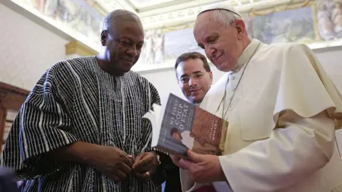 AFP Pope Francis exchanges gifts with President of Ghana John Dramani Mahama during an audience at the Apostolic Palace.