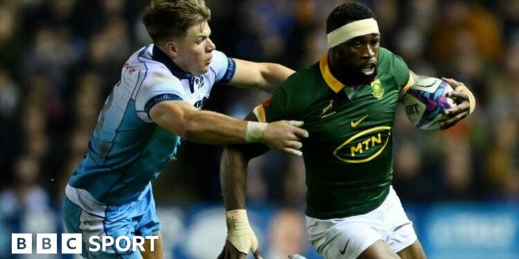 Siya Kolisi of South Africa runs with the ball whilst under pressure from Huw Jones of Scotland during the Autumn Nations Series 2024 match between Scotland and South Africa at the Scottish Gas Murrayfield