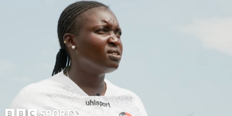 Jackline Juma is pictured wearing a white training shirt, with her black hair braided and two earrings in her right ear