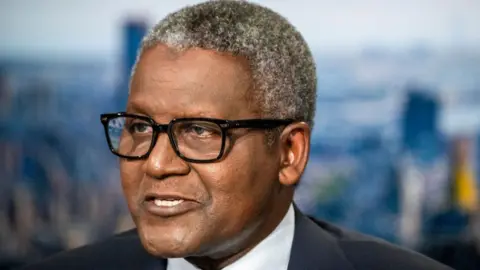 Getty Images A close-up of Aliko Dangote as he gives a television interview in New York, US, on 23 September 2024. He is wearing glasses and has short, grey hair