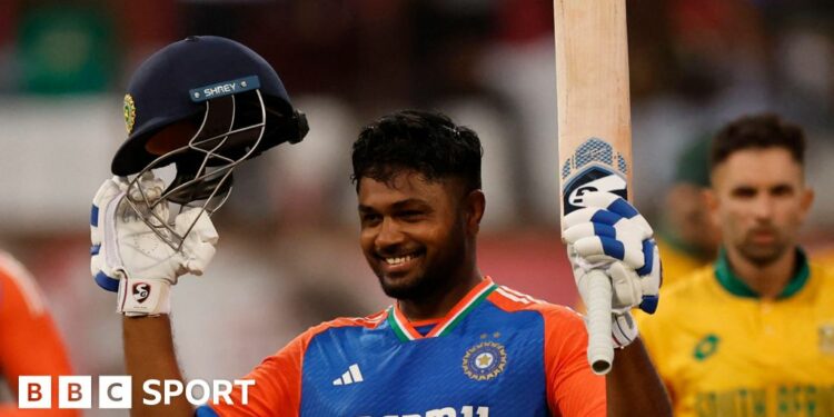 India opener Sanju Samson raises his bat to celebrate scoring a century against South Africa