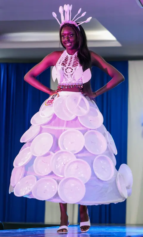 Daniel Irungu / EPA A model wearing a paper plate and cutlery inspired dress showcases her creation at the 11th edition of the South Sudan Theatre Awards 2024 (STA), in Nairobi, Kenya - Wednesday 18 December 2024.