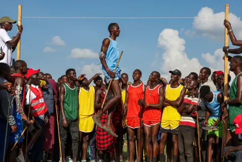 Daniel Irungu / EPA A Maasai warrior captured mid-air as he competes in the high jump event in Kajiado, Kenya - Saturday 14 December 2024