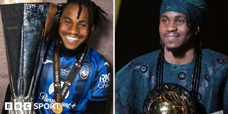 Ademola Lookman, wearing a traditional dark green Nigerian robe and matching hat, stands at a podium to give a speech after being named African Footballer of the Year