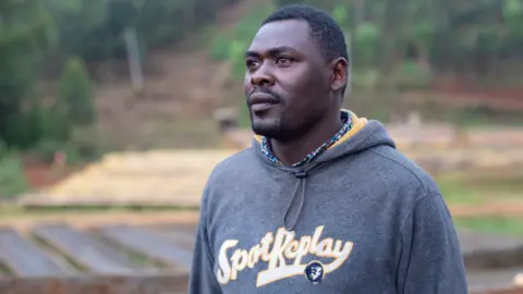 Kate Stanworth Simon Macharia, one of the Kenyan coffee farmers stands a coffee processing plant in Komothai, Kenya