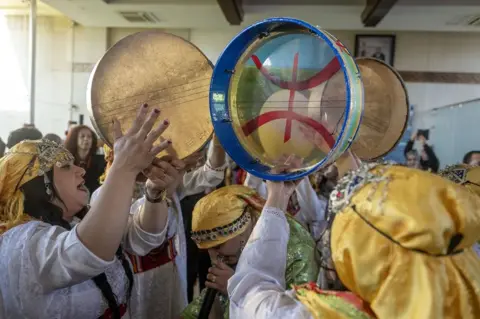 JALAL MORCHIDI / EPA Women play tambourines and sing.