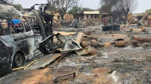 Getty Images This picture taken on 1 September 2023 shows a view of destruction - including burned out cars - in a livestock market area in al-Fasher, the capital of Sudan's North Darfur state. 