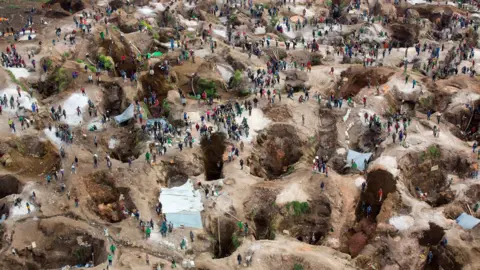 Monusco An aerial view of a coltan mine with open pits dotted across the landscape.