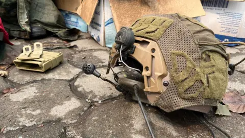 A military helmet lies on the ground